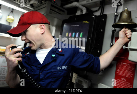 U.S. Navy Hull Maintenance Technician 2nd Class Paris Luh stands a watch in damage control central aboard USS Blue Ridge (LCC 1 Stock Photo