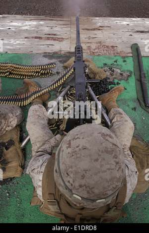 U.S. Marine Corps Cpl. Robert Dyke fires an M2 .50-caliber machine gun during the crew served weapons firing exercise on a rang Stock Photo