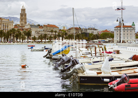 fishing boats lie moored at matejuska in split croatia. in the background is seen the riva promenade and st domnius cathedral