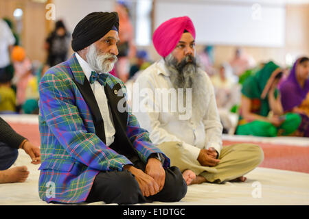 Glasgow, UK. 01st June, 2014. A Sikh man wearing a Singh tartan jacket waits to hear the First Minister Alex Salmond address members of the Scottish Sikh community during a visit to the Glasgow Gurdwara on Sunday 01 June 2014 in Glasgow, Scotland. © David Gordon/Alamy Live News Stock Photo