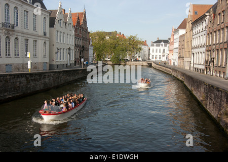 Tourist boats on canal in Bruges Stock Photo