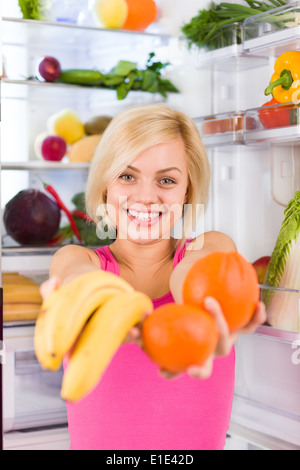 woman banana orange refrigerator Stock Photo