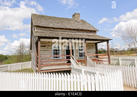 Old fashioned wooden American farm house with a white picket fence Stock Photo