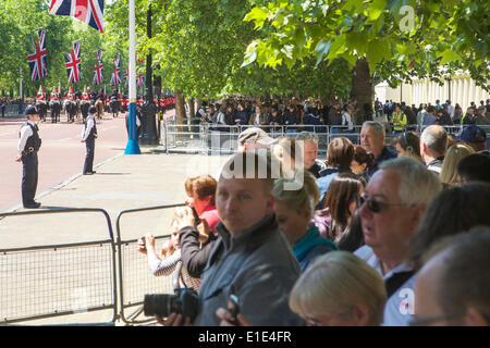 London, UK. 31st May, 2014. Trooping the Colour (rehearsal), London UK, 31st May 2014. There are two reviews / rehearsals of Trooping the Colour, prior to the Queen’s Birthday Parade. (This is the first rehearsal.)  Spectators in The Mall, with flying Union Jack flags, watch the Household Cavalry and Guards march by. Policemen on crowd control. Credit:  Alamy Live News Stock Photo