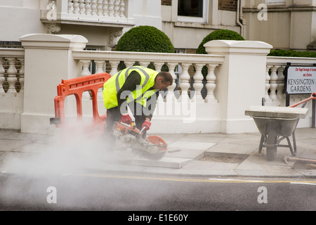 Construction worker cutting cement Stock Photo