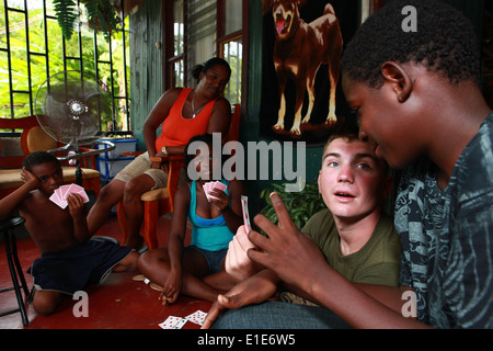 U.S. Marines play cards with a Costa Rican family near an engineering site in Limon, Costa Rica, Aug. 23, 2010. The Marines are Stock Photo