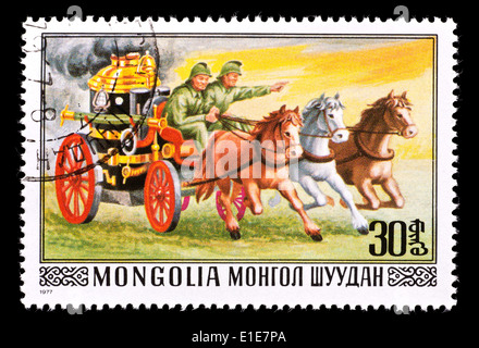 Postage stamp from Mongolia depicting an old fire engine being pulled by a team of horses. Stock Photo