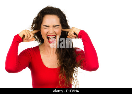 A very fed up and frustrated woman screaming and covering her ears. Isolated on white. Stock Photo