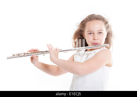 young girl playing the flute against white background in studio Stock Photo