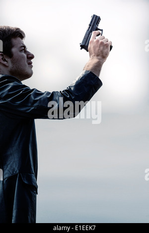a man aiming with a gun Stock Photo
