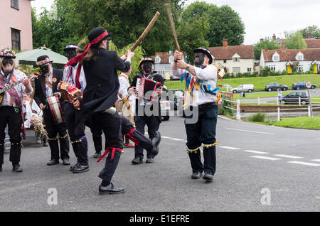 Silurian morris men from Ledbury in Herefordshire dancing at the Fox Inn Finchingfield  Essex, UK. on 31st May 2014.  This style of morris dancing with a black face is traditional in the Welsh borders.  The farm hands did it to prevent the farmer finding who they were.  This is part of the morris ring festival which is held annually in Thaxted Stock Photo