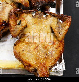 grilled chicken covered with crisp cooked on the stove Stock Photo