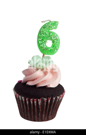 Mini cupcake with birthday candle for six year old isolated on white background Stock Photo