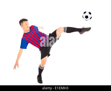 Young soccer player Steals the flying ball Stock Photo