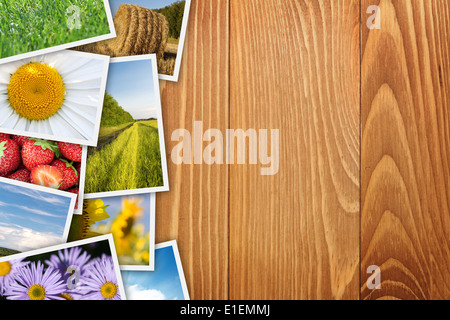 Stack of printed pictures collage on wooden table with copy space for your text or photo Stock Photo