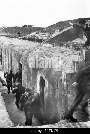 The picture from a Nazi news report shows German soldiers during an attack on the Atlantic Wall in February 1944. The original Nazi propaganda text on the back reads, 'Early morning on the channel. The men are half asleep. The alarm sounds suddenly! It's time! The steel helmets can be put on on the way. The point is, to be ready to fire as quick as possible.' Fotoarchiv für Zeitgeschichtee - NO WIRE SERVICE Stock Photo