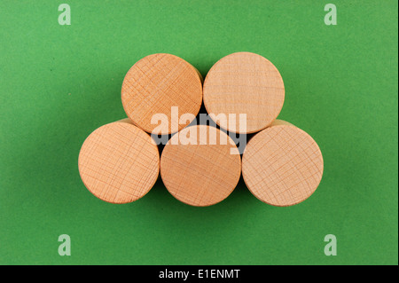 wooden geometric shapes on a green background Stock Photo