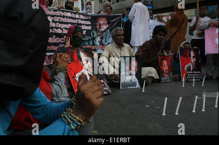 Relatives of missing Baloch persons are protesting against their kidnapping as they are demanding for their recovery during a demonstration under the umbrella of Baloch Students Organization (AZAD) held at Karachi press club on Monday, June 02, 2014.