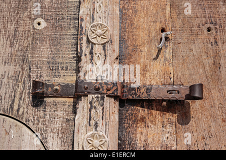 old deadbolt on wooden door Stock Photo