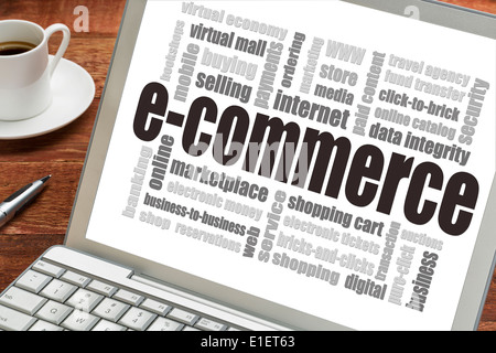 e-commerce word cloud on a laptop screen with a cup of coffee - internet business concept Stock Photo