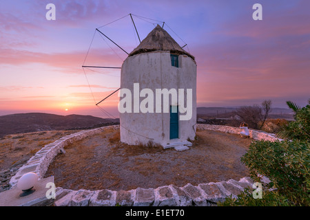 Sunset at an old traditional windmill in Dryopida (Driopida) village, a landmark of Kythnos island, Cyclades, Greece Stock Photo