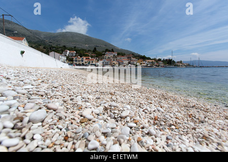 Village of Agia Efimia, Kefalonia. Agia Efimia’s pebbly beach with the waterfront Taverna’s in the background. Stock Photo