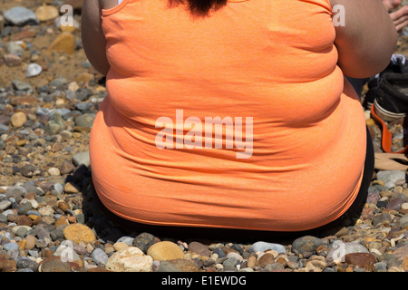 Overweight woman on beach. UK Stock Photo