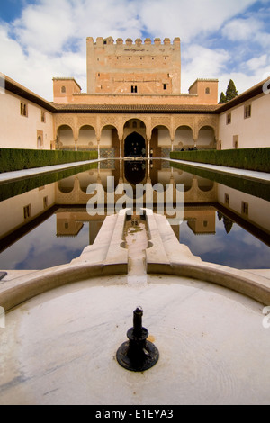 Comares tower reflected in the pond of the Court of the Myrtles in La Alhambra, Granada, Spain. Stock Photo