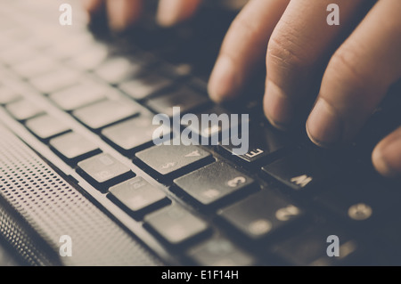 Two hands typing on a black keyboard. Stock Photo