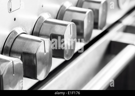 Close up image of stainless steel cooker knobs Stock Photo