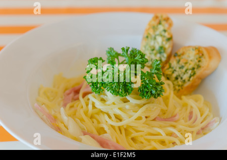 Spaghetti Carbonara with bacon and garlic bread on dish Stock Photo