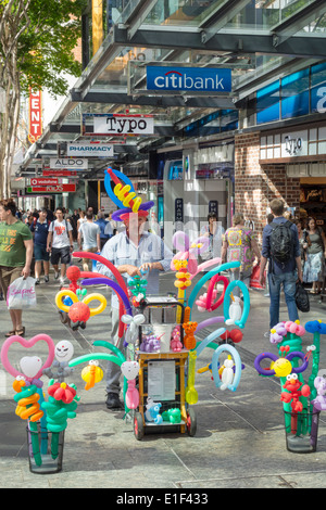 Brisbane Australia,Queen Street mall,balloon,man men male,sculptor,vendor vendors stall stalls booth market marketplace,buyer buying selling,AU1403130 Stock Photo