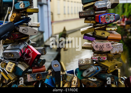 Love locks locked on a bridge fence in Prague representing secure friendship and romance Stock Photo