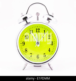 Alarm clock on white background. Showing time five minutes before twelve Stock Photo