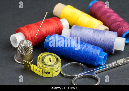 Black thread spool with needle Stock Photo - Alamy