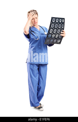 Full length portrait of a worried female doctor looking at an x-ray Stock Photo