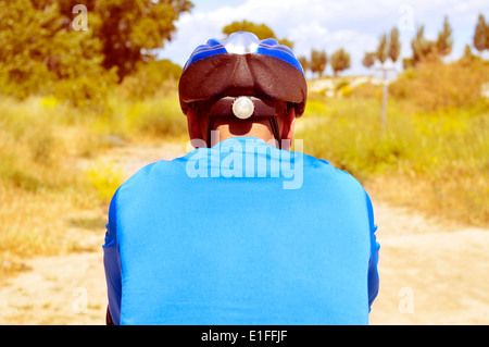 a young man riding a mountain bike on a dirt road Stock Photo