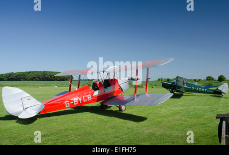 DH82A De Havilland Tiger Moth G-BYLB and De Havilland DH87B Hornet Moth biplanes at Northrepps Airfield in Norfolk Stock Photo