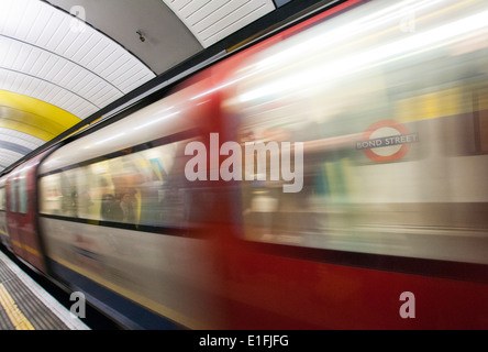 A train moving through a station on the London Underground, England UK Stock Photo