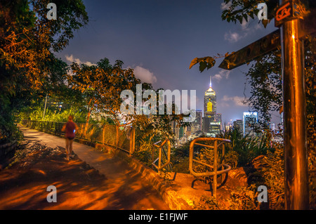 A woman runs along the Bowen Road fitness trail at night, Wan Chai, Hong Kong Stock Photo