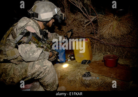 Afghan National Army soldiers conduct a nighttime search for Taliban insurgents during a joint operation with US Army soldiers August 8, 2013 in Zharay district, Kandahar province, Afghanistan. Stock Photo