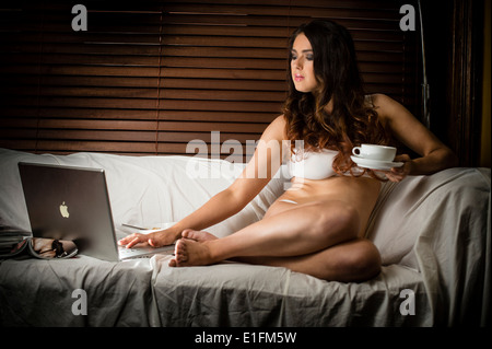 Brunette girl in underwear lying on a bed Stock Photo by ©Nick_Freund  28475407