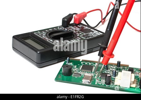 electronic boards and digital multimeter isolated on a white background Stock Photo