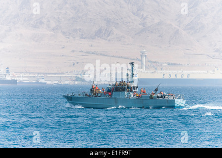 Eilat. Israeli patrol boat near the nautical border with Jordan. The Jordanian harbor of Aqaba in the background. Stock Photo