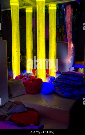 Bubble towers and fibre optic lighting in a disability charity sensory room - yellow (4/4) Stock Photo