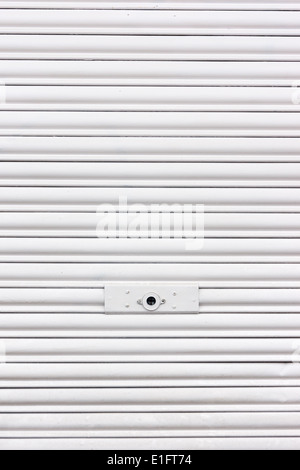 background of metallic roller shutter with door lock Stock Photo