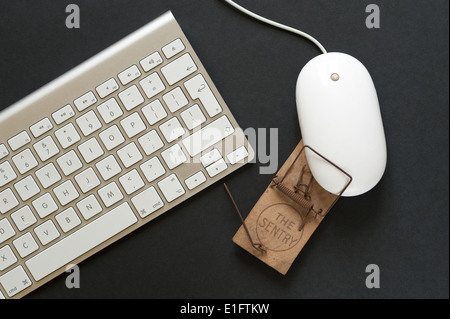 old wooden mousetrap pre digital used to trap new computer mouse of modern technology Stock Photo