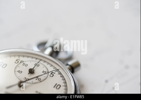 old silver chrome stopwatch with seconds and minute hands 5 second count down chronological timer glass dial buttons against Stock Photo