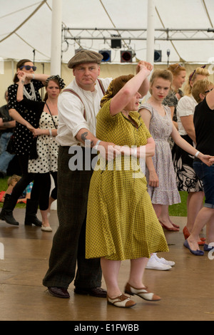 Couple dancing the Lindy Hop at a 1940s Vintage show in England Stock Photo