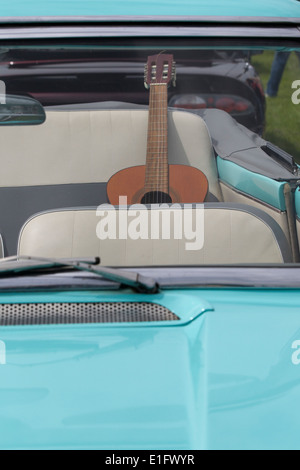 Guitar on the back seat of a convertible light blue Cadillac Stock ...